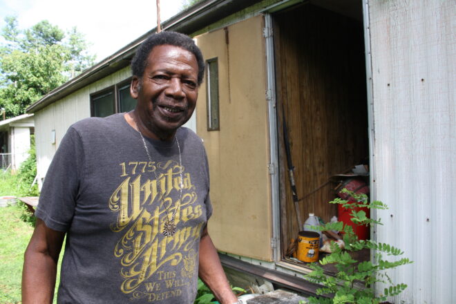Man standing beside mobile home
