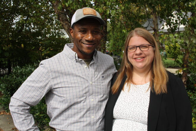 Man standing next to woman