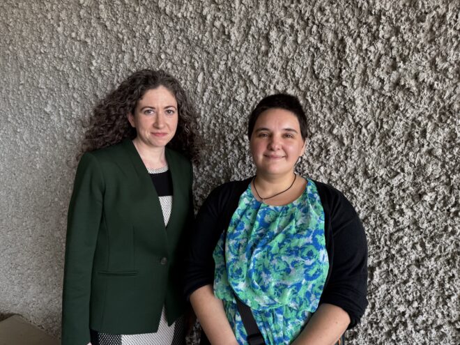 Woman standing next to woman